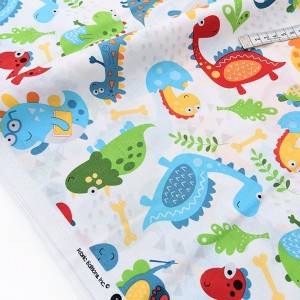 Destock 1.06m tissu américain patchwork dinosaure fond blanc largeur 112cm