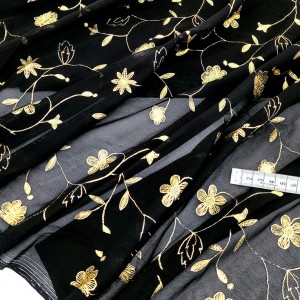 Destock 1.07m tissu tulle élastique fluide imprimé fleuri doré noir largeur 110cm
