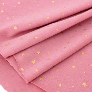Tissu jersey coton doux étoiles dorées fond vieux rose x50cm 