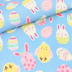 Tissu américain thème Pâques les lapins poussins œufs fond bleu x 50cm 